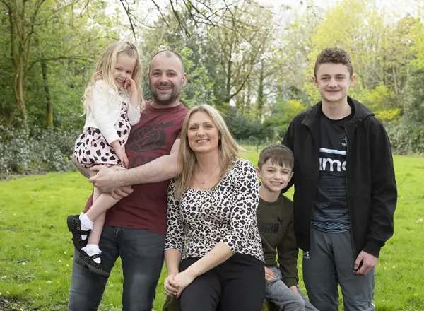 A photo of Christie patient Lyndsey Ainscough, her husband Christian and her children, Perry Spencer and Alfie in a park.