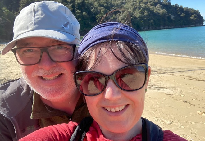 A photo of Christie patient Duncan Edmonstone with his wife Kay on a beach in New Zealand.