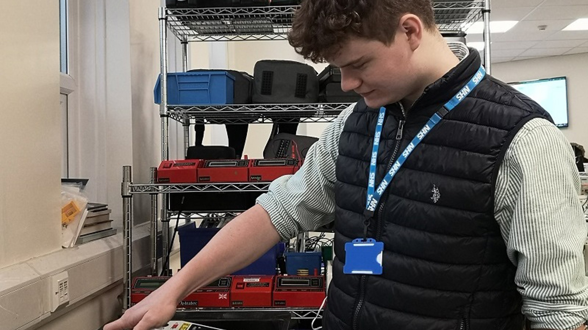 A photo of a man in the clinical engineering department at The Christie testing a piece of equipment.