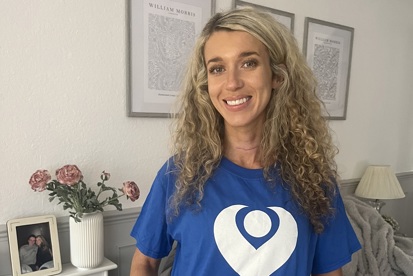 A photo of Christie patient and fundraiser Beth Gallagher wearing a Christie Charity t-shirt that reads "Join The Christie against cancer".