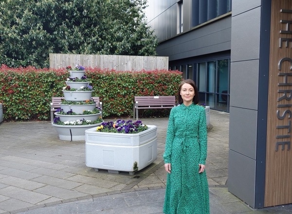 A photo of Christie patient Sarah on her first day of treatment outside The Christie proton beam therapy centre.