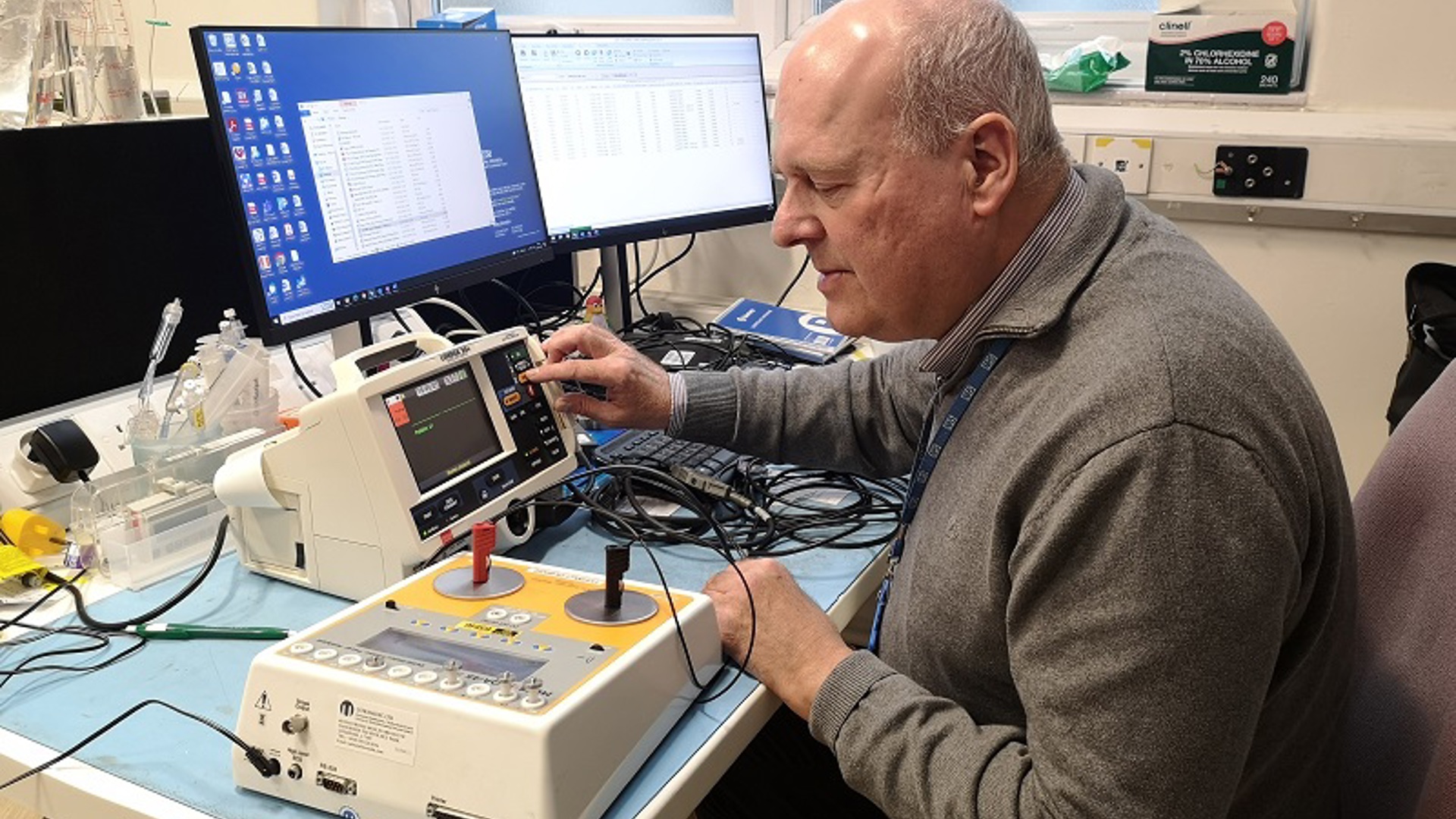 A photo of a man in the clinical engineering department at The Christie testing a piece of equipment and looking at a screen.