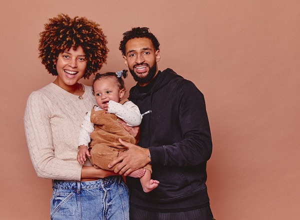 A photo of Christie patient Paige with her partner Deano and their baby.