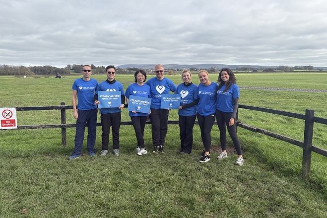 A photo of a team from Pareto wearing Christie Charity t-shirts and standing in a field.