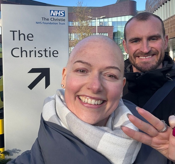 A photo of Christie Charity fundraiser Tom Reade and his wife Alexis outside the Christie hospital main entrance.