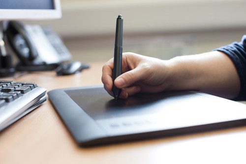 Image of someone using a pen on a touch screen tablet computer