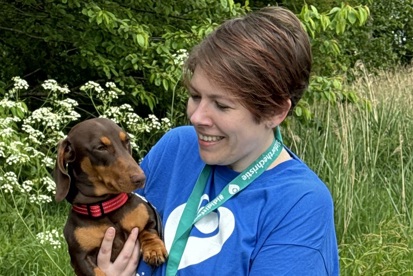 A photo of Christie patient and fundraiser Kat Watson-Wood holding a dog.