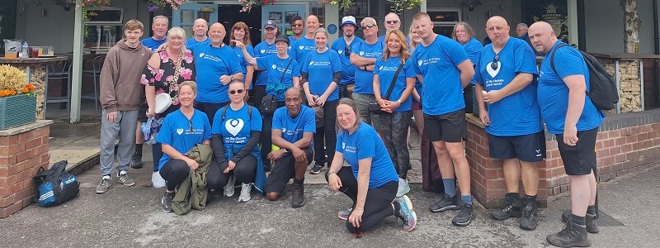 A large group of walkers in Christie Charity t-shirts.