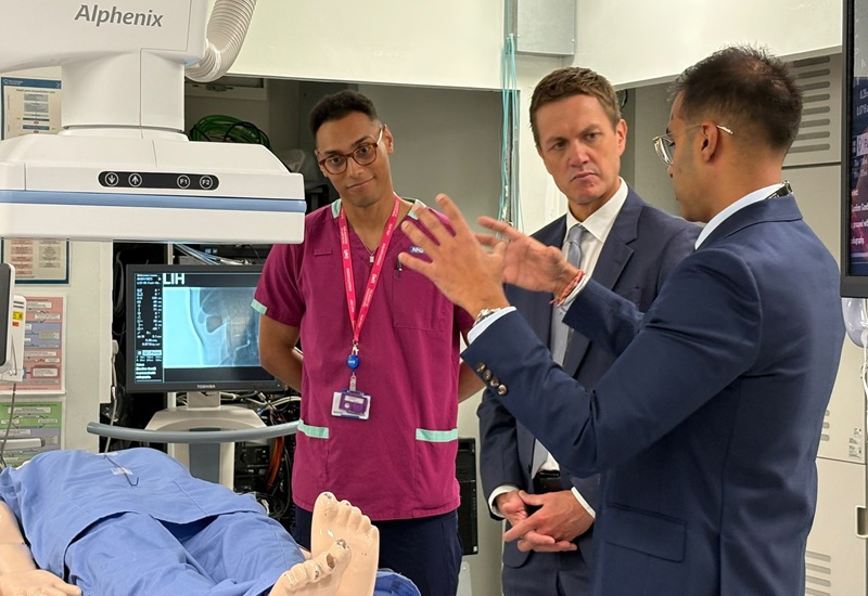 A photo of Minister James Frith MP, Parliamentary Under-Secretary of State for Health Innovation at the Department of Health and Social Care at The Christie with Dr Pavan Najran and a diagnostic radiographer.