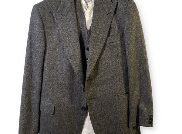A photo of a grey tailored three-piece suit.