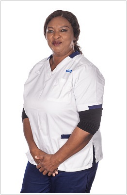 A photo of a physiotherapist wearing a uniform in white with navy trim.