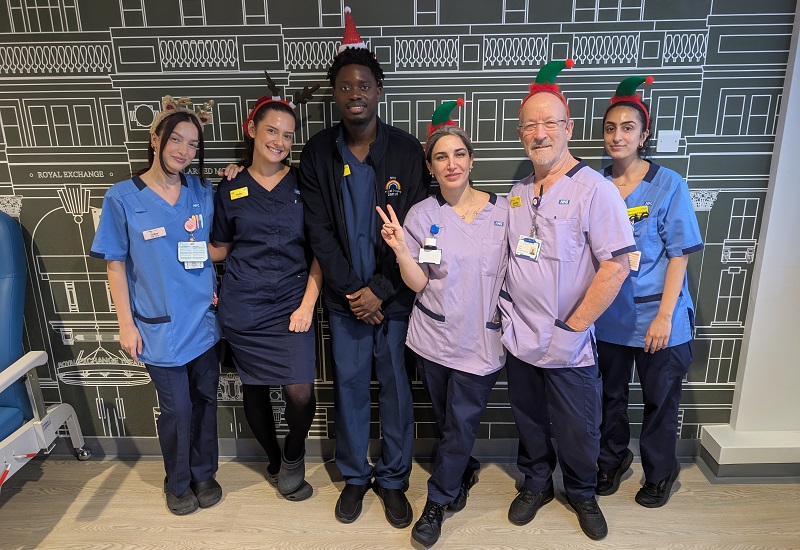 A photo of Grace Garbett and India Hallgate, and the rest of the ward 12 team at The Christie wearing Christmas headbands.