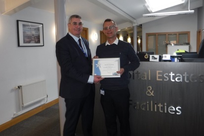 A photo of Richard Timperley, senior catering manager at The Christie, receiving his You Made a Difference award from Roger Spencer, chief executive at The Christie.