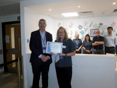 A photo of Roger Spencer presenting Sandra Boe with her Christie You Made A Difference Award.