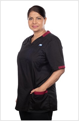 A photo of a senior nurse or senior Allied Health Professional wearing a uniform in black with dark red trim.