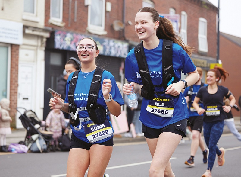A photo of a 2 women running in Christie Charity t-shirts.