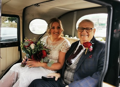 A photo of Christie patient Terry Berry and his daughter Carla in a wedding car for Carla's wedding.