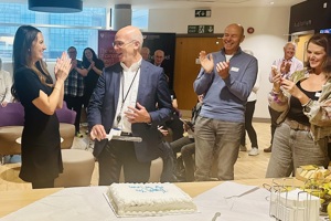 A photo of Rebecca Halstead, Lead clinical nurse specialist at the Colorectal and Peritoneal Oncology Centre at The Christie with surgeon Mr Malcolm Wilson as he cuts a cake to celebrate his retirement.
