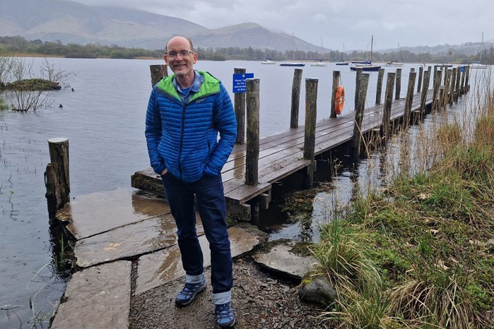 A photo of Christie fundraiser David Battersby in front of Derwent Water reservoir.