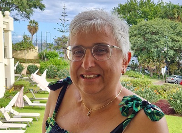 A photo of Christie patient Liz Bates standing in a garden.