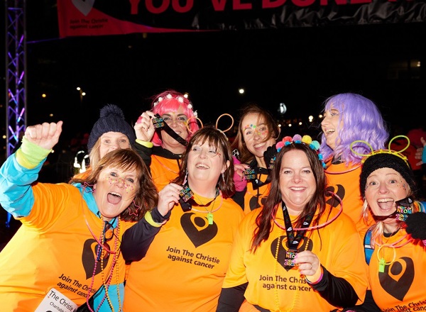A photo of a group of women showing medals to the camera at The Christie Charity Night of Neon event.