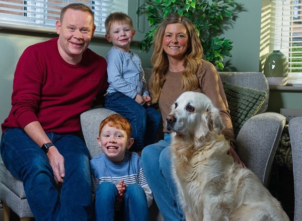 A photo of Vicki Steyert with her 2 young sons, Alex and Charlie, her husband Rob and Golden Retriever dog.