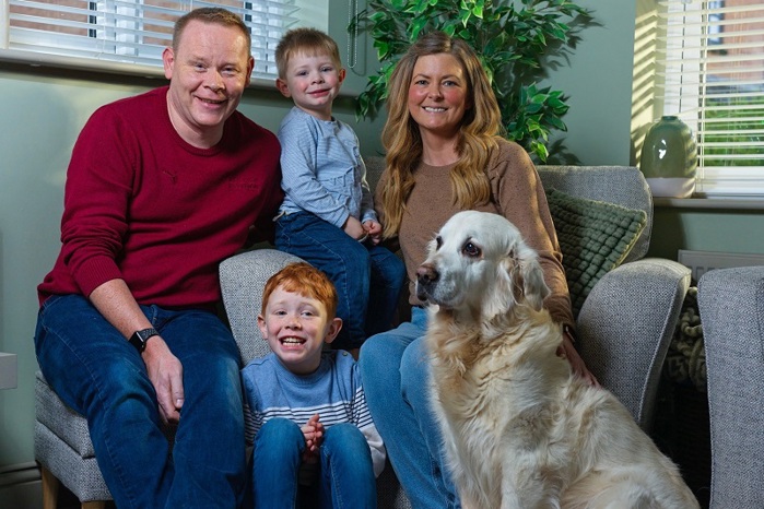 A photo of Vicki Steyert with her 2 young sons, Alex and Charlie, her husband Rob and Golden Retriever dog.