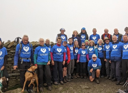 A photo of Christie Charity fundraiser Jackie Gallimore and a group of other fundraisers at the peak of a mountain after completing a trek in support of The Christie Charity.