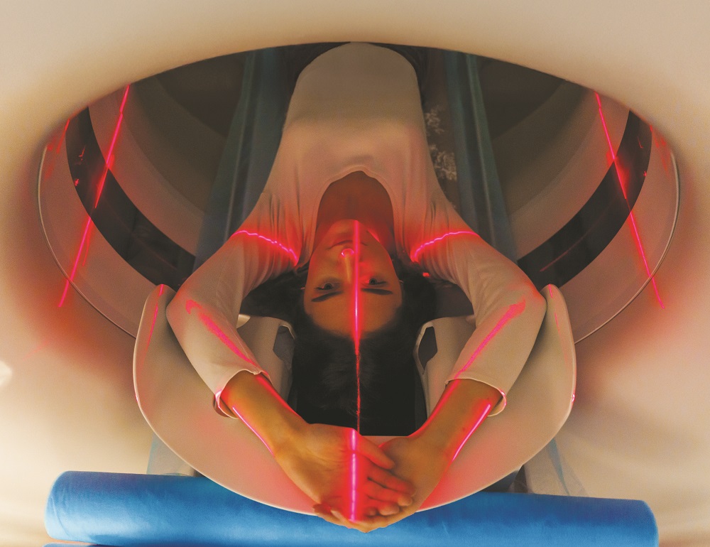 A photo of a woman in a scanner.