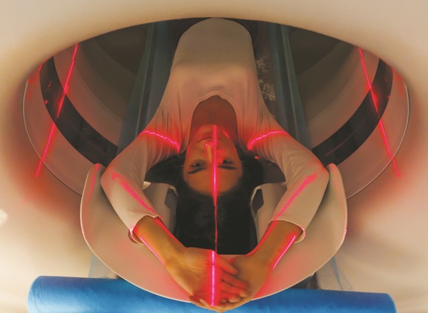 A photo of a woman in a scanner.