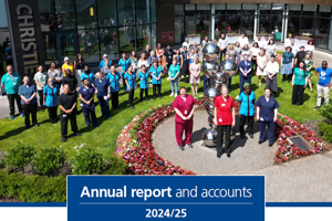 An image of the cover of The Christie's Annual report and accounts for the year 2024 to 2025. The cover features a photo of a large group of staff members standing outside the main entrance for The Christie.