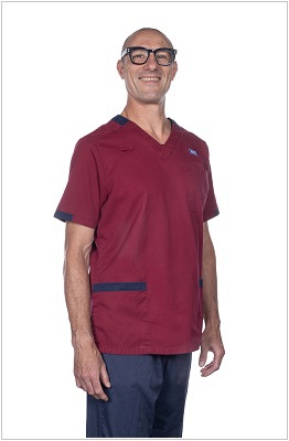 advanced practitioner wearing a uniform in dark red with navy trim.