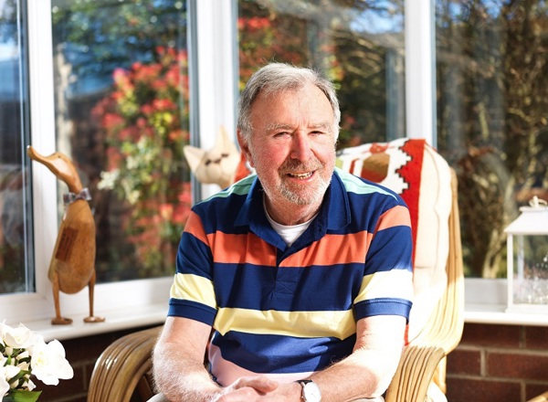 A photo of Christie patient Jeff Cook sitting in a conservatory.