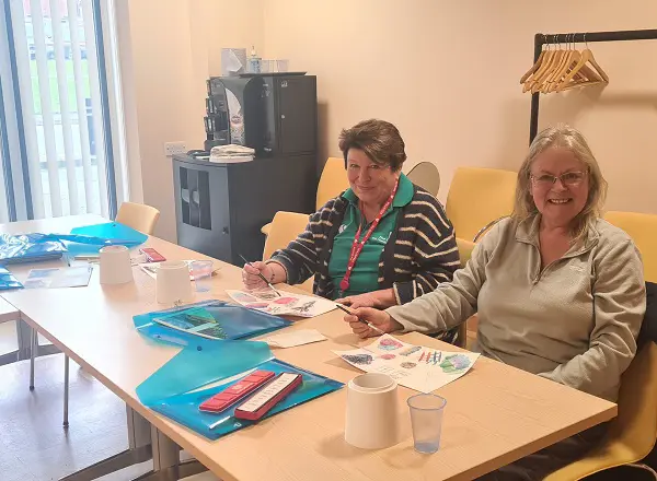 A photo of Christie patient Michelle Hardiman with a staff member at an art class.