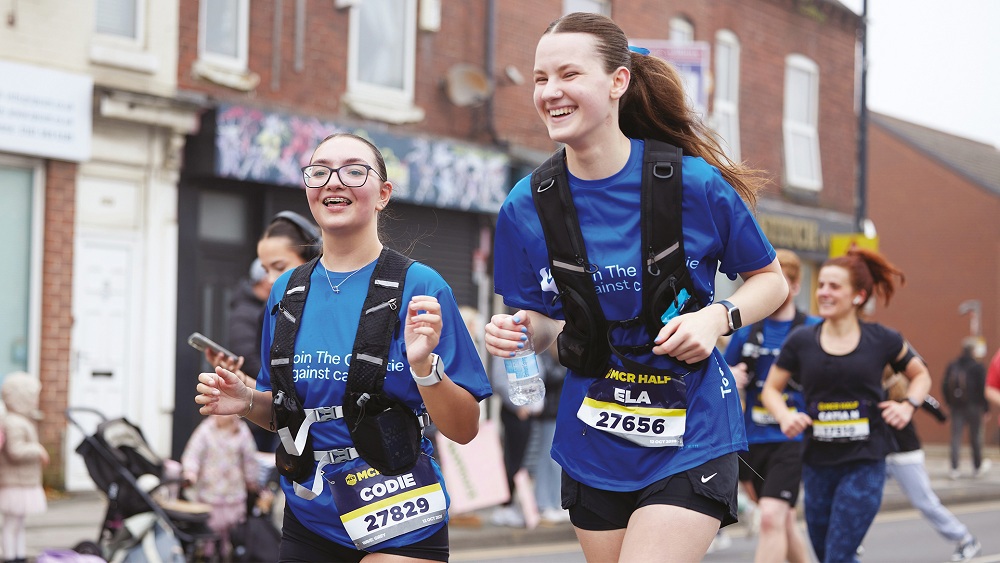 A photo of a 2 women running in Christie Charity t-shirts.
