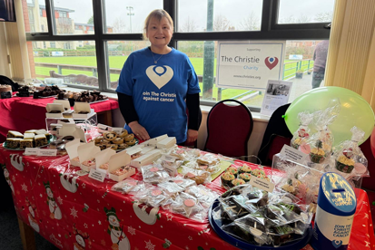 A photo of Christie Charity fundraiser Becky Swift at a charity cake sale.
