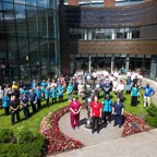 A photo of a large group of staff members standing outside the front of The Christie.