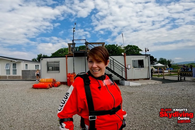 A photo of Christie patient Kat Watson-Wood wearing a skydiving outfit; the bottom right-hand corner reads 'Black Knights Skydiving Centre'.