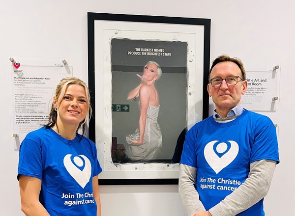 A photo of Manchester Cancer Research Centre’s Sally Best and consultant Dr Sacha Howell standing in front of the Sarah Harding plaque at The Christie.