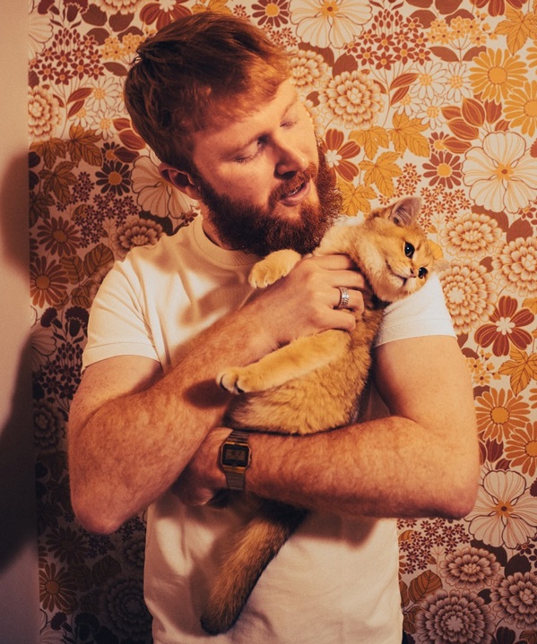 A photo of Christie patient Patrick Meehan holding a cat.
