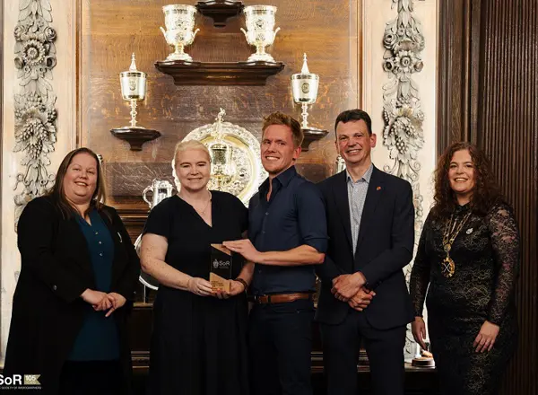 A photo of the radiotherapy clinical trials team from The Christie accepting their North West Radiography Team of the Year and UK Radiography Team of the Year awards from the Society of Radiographers.