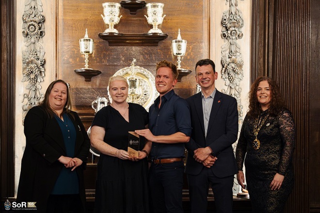 A photo of the radiotherapy clinical trials team from The Christie accepting their North West Radiography Team of the Year and UK Radiography Team of the Year awards from the Society of Radiographers.