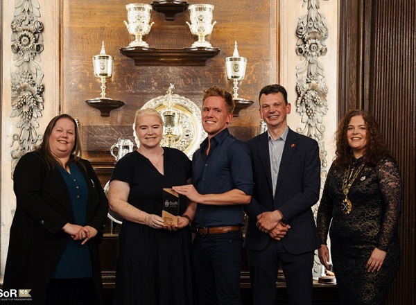 A photo of the radiotherapy clinical trials team from The Christie accepting their North West Radiography Team of the Year and UK Radiography Team of the Year awards from the Society of Radiographers.